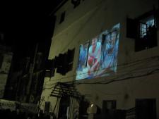 kids watching film in the street